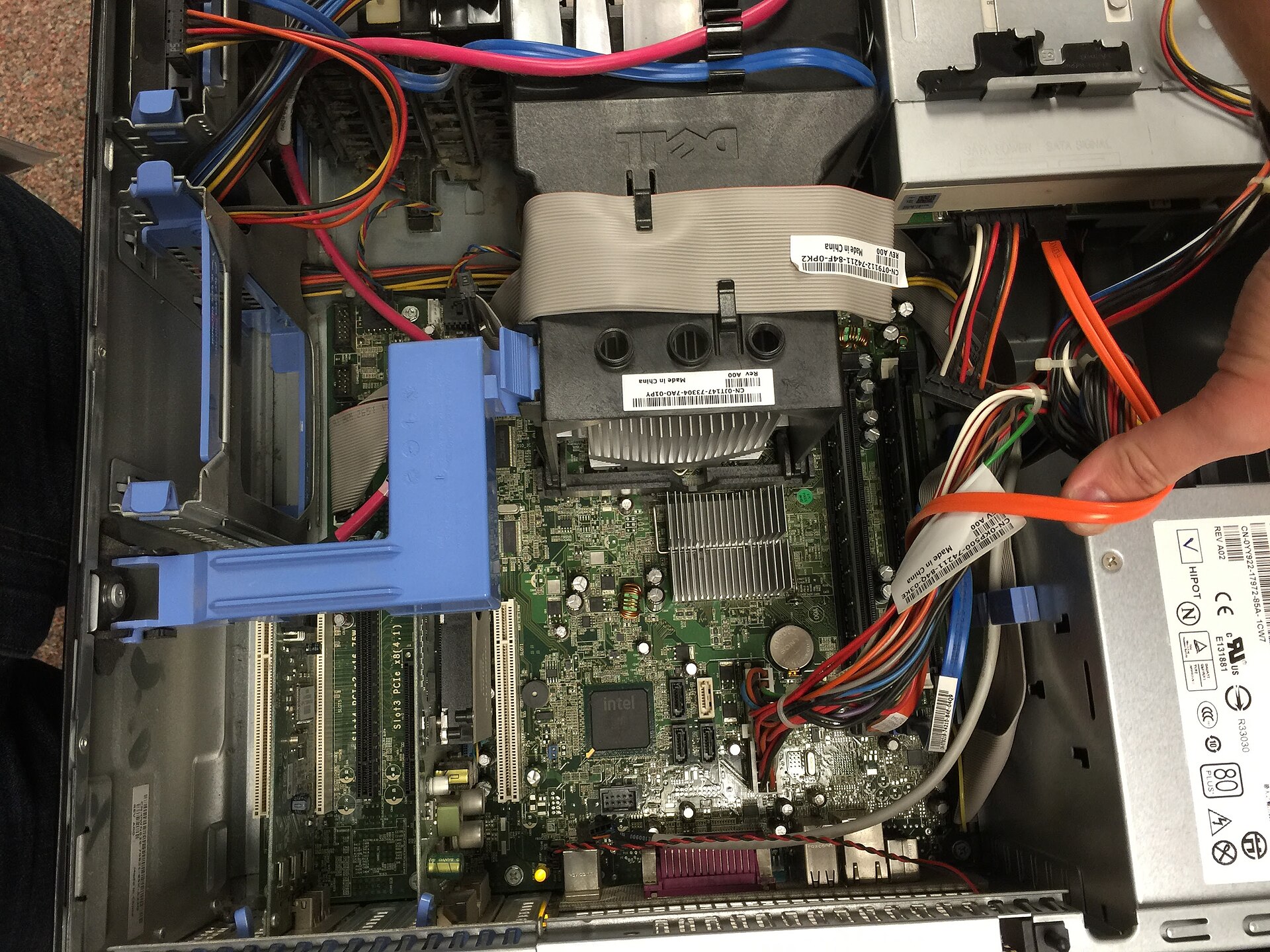 An open computer case showing the motherboard, heatsinks and power cables.